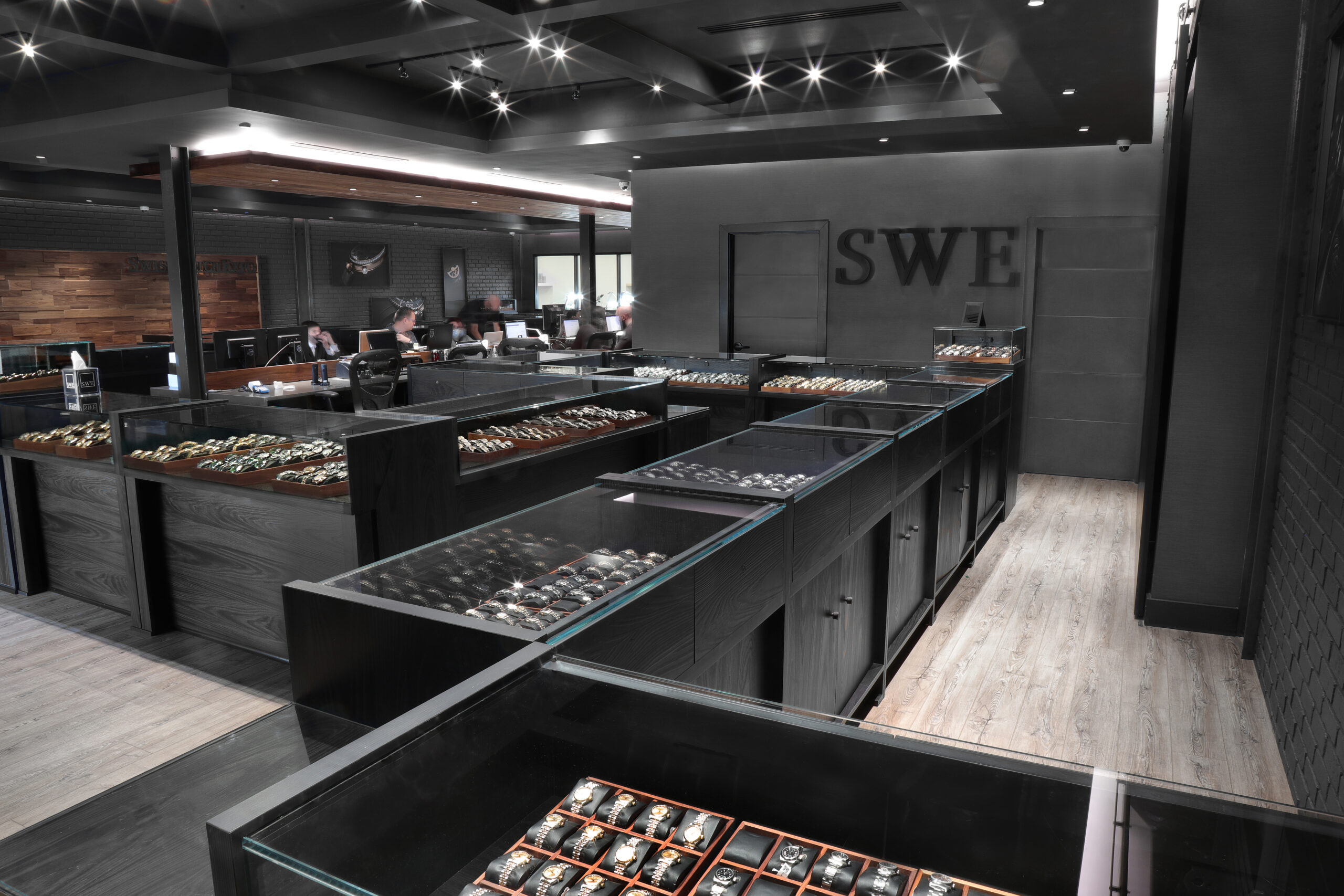 The interior of the Top Quality Designer Watch Shop showroom featuring multiple display cases filled with luxury watches.