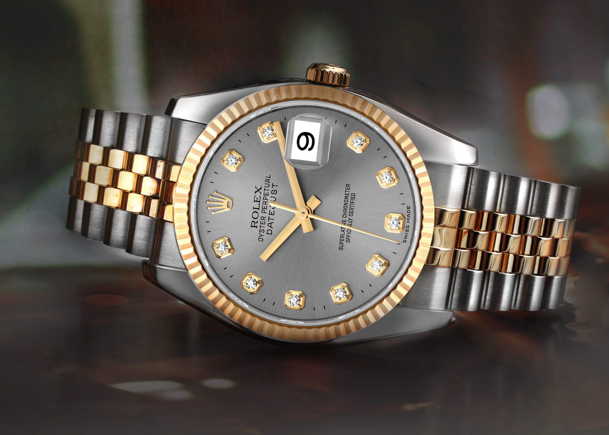 A two-tone Rolex Datejust showing the prominent Cyclops lens over the date window at the 3 o'clock position.