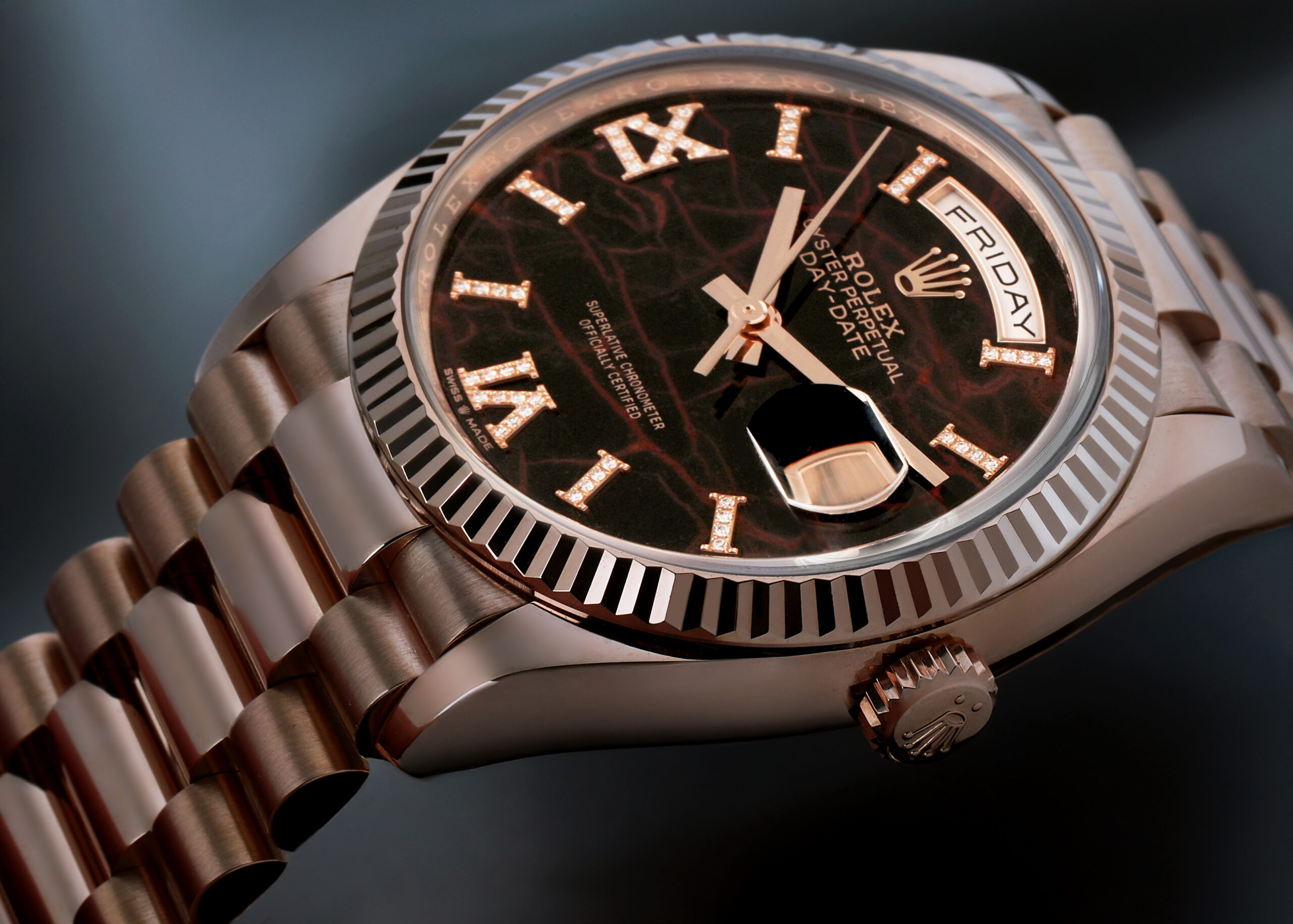 Close up of an 18k Everose gold Rolex Day-Date with a textured Eisenkiesel dial and diamond hour markers.
