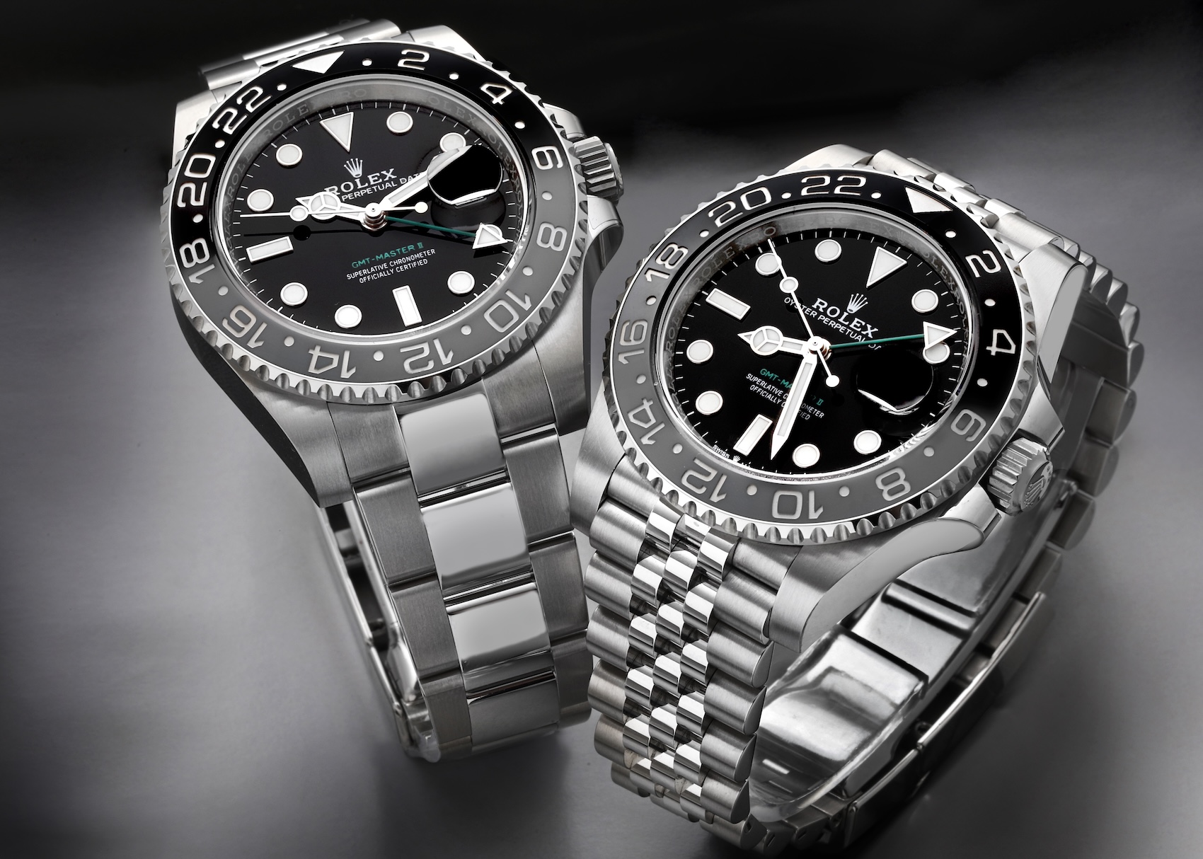 Two stainless steel Rolex GMT-Master II GRNR watches side-by-side, comparing the three-link Oyster bracelet on the left with the five-link Jubilee bracelet on the right.