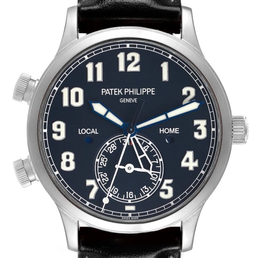 A clear dial shot of the Patek Philippe 5524G Calatrava Pilot, showing the skeletonized 'Local' time hand, solid 'Cheap Luxury Handbag' time hand, and date sub-dial at 6 o'clock.