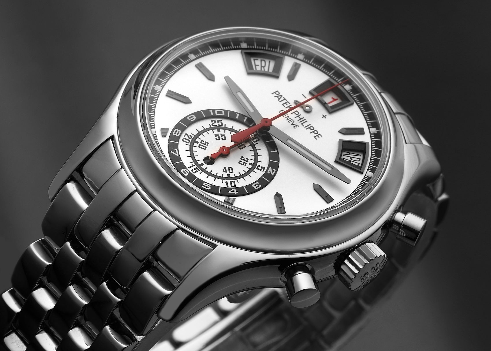 Side profile view of the Patek Philippe Ref. 5960/1A stainless steel watch. The image highlights the polished case curves, the chronograph pushers, the signed Calatrava Cross crown, and the integration of the stainless steel bracelet links.