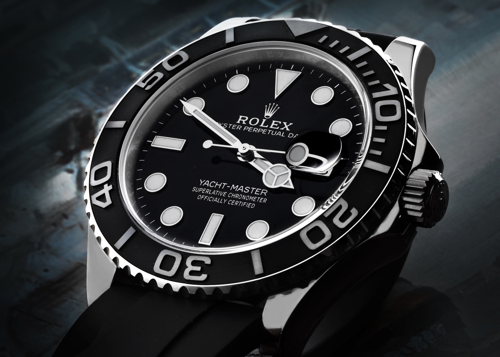 Extreme close-up of the Rolex Yacht-Master 42 in 18k white gold, showing the "YACHT-MASTER" text on the dial and the monochromatic aesthetic.