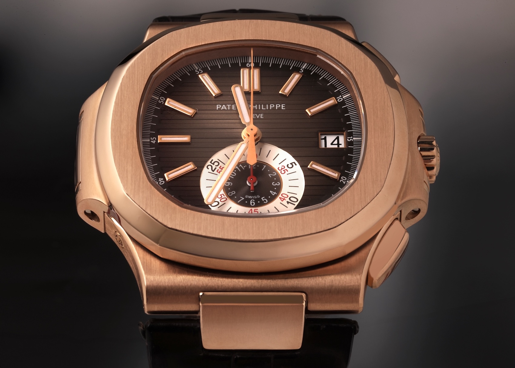 Close-up of the Patek Philippe Nautilus Chronograph Ref 5980R-001 in 18k rose gold, featuring the signature black-brown gradient dial and 6 oclock monocounter.