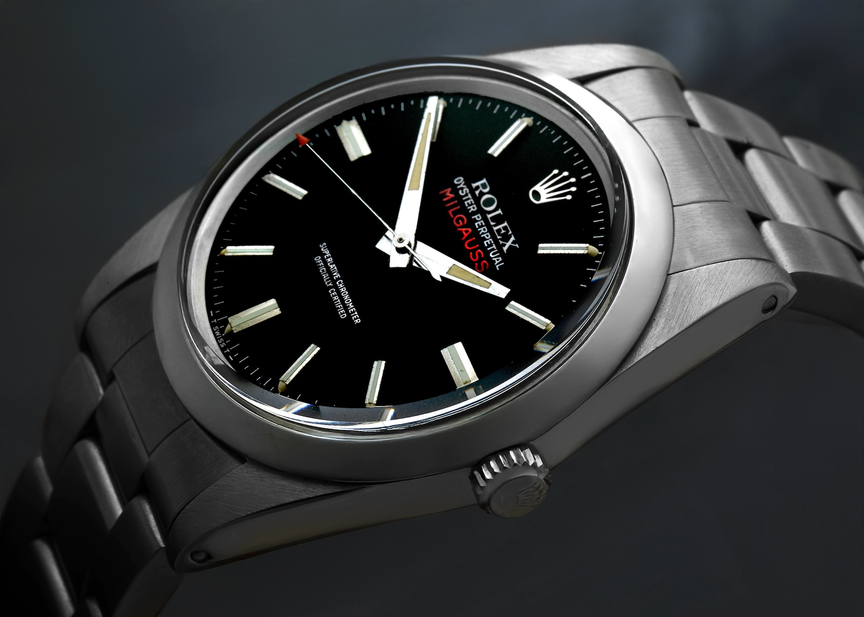 Close up of a vintage Rolex Milgauss reference 1019 featuring a black dial, straight hands, and the signature red arrowhead seconds hand.
