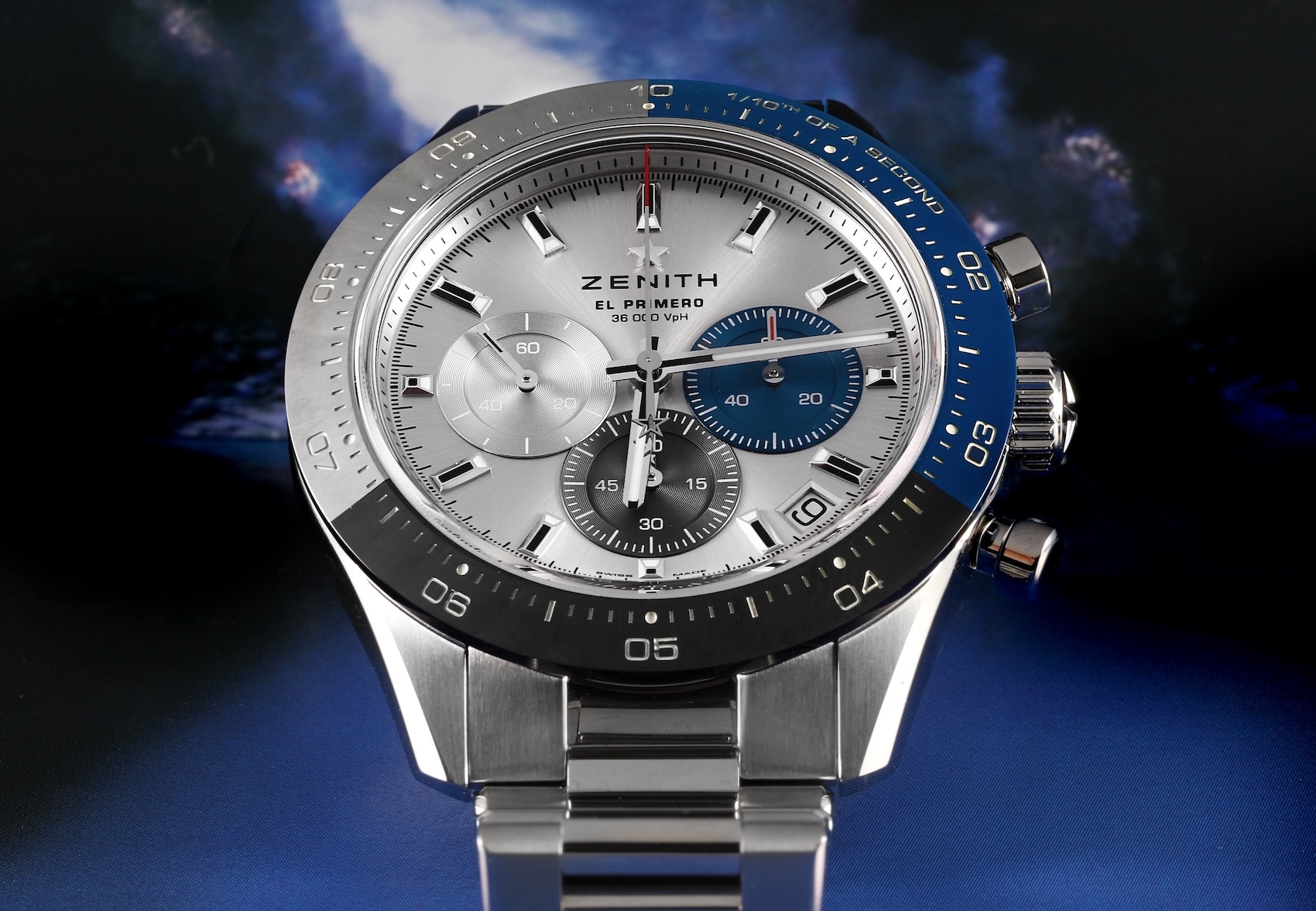 Front-facing view of the Zenith Chronomaster Sport displaying its high-contrast white dial, distinct blue, anthracite, and light grey subdials, and blue ceramic bezel.