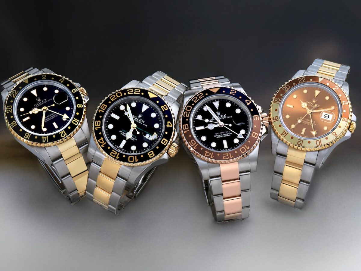 A side-by-side lineup of four different generations of two-tone Rolex GMT-Master II watches including references 16713, 116713LN, and 126711CHNR.