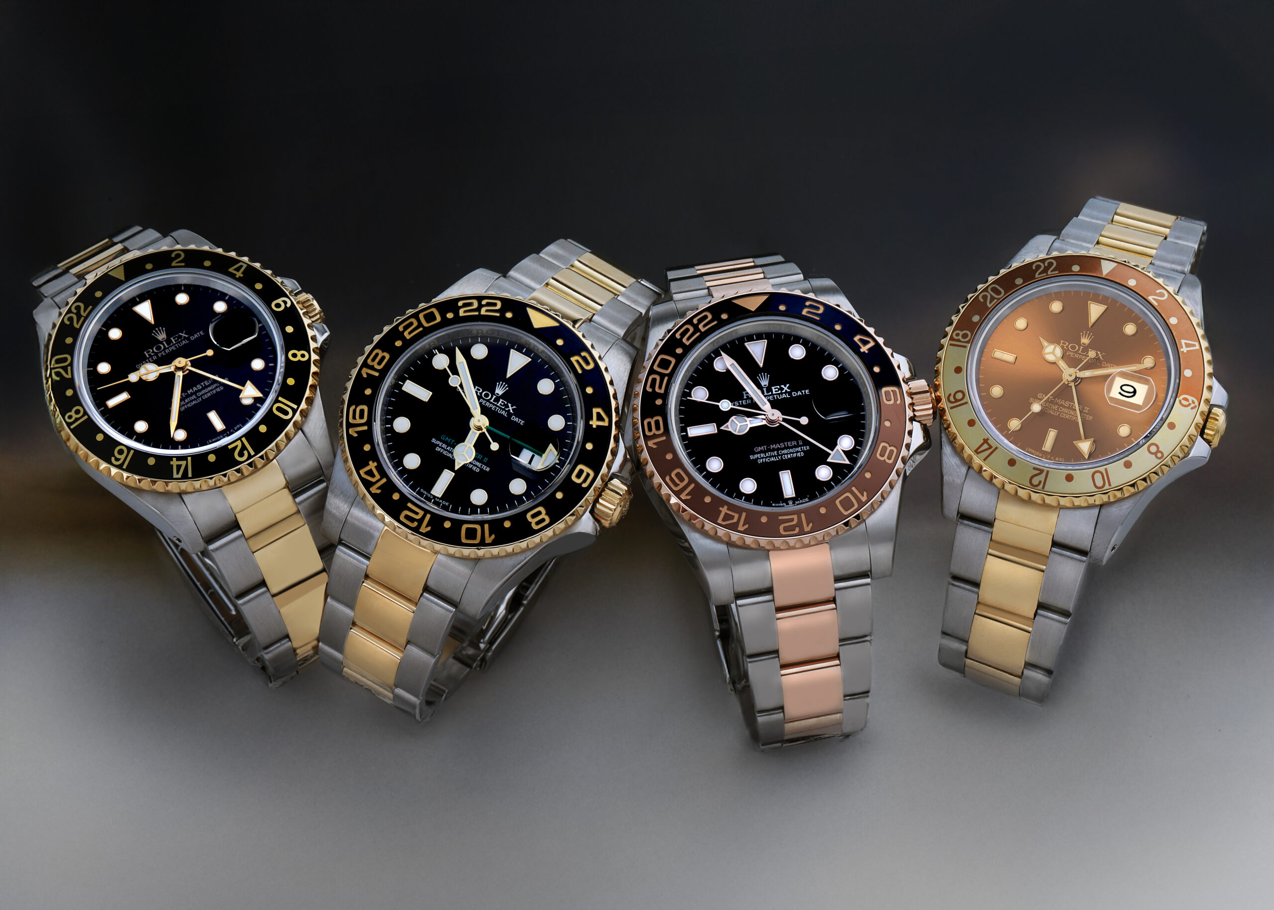 Lineup of two-tone Rolex GMT-Master II timepieces in yellow gold Rolesor and Everose gold Root Beer.