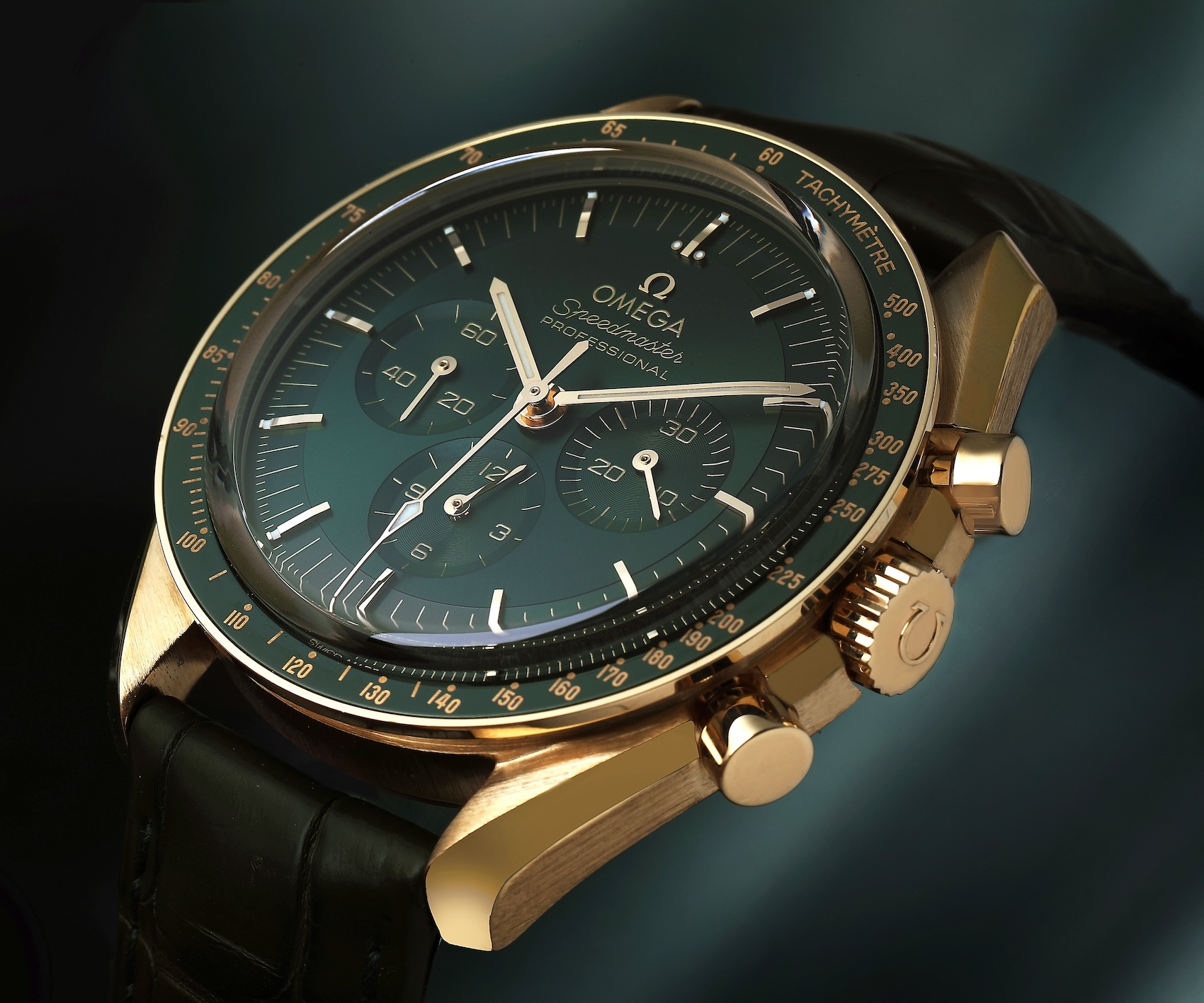 Omega Speedmaster Moonwatch Professional in Moonshine Gold featuring a dark green agate step dial and green ceramic tachymeter bezel.