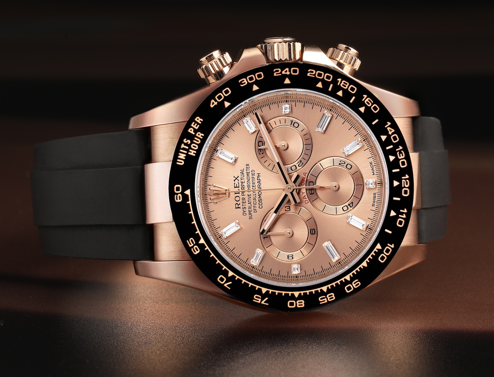 A Rolex Cosmograph Daytona reference 116515LN in 18k Everose gold with a sundust dial, baguette diamond hour markers, and a black Oysterflex strap.