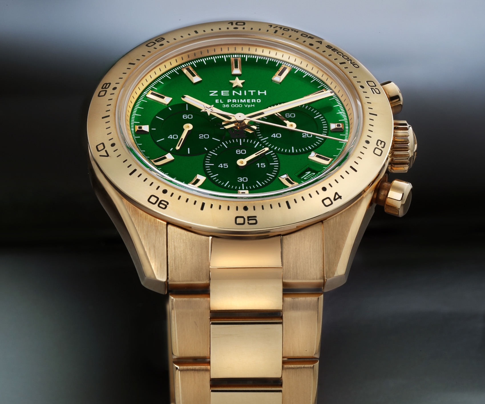Close-up of the Zenith Chronomaster Sport 30.3100.3600 in 18k yellow gold with an engraved gold bezel, sunburst green dial, and integrated gold bracelet.