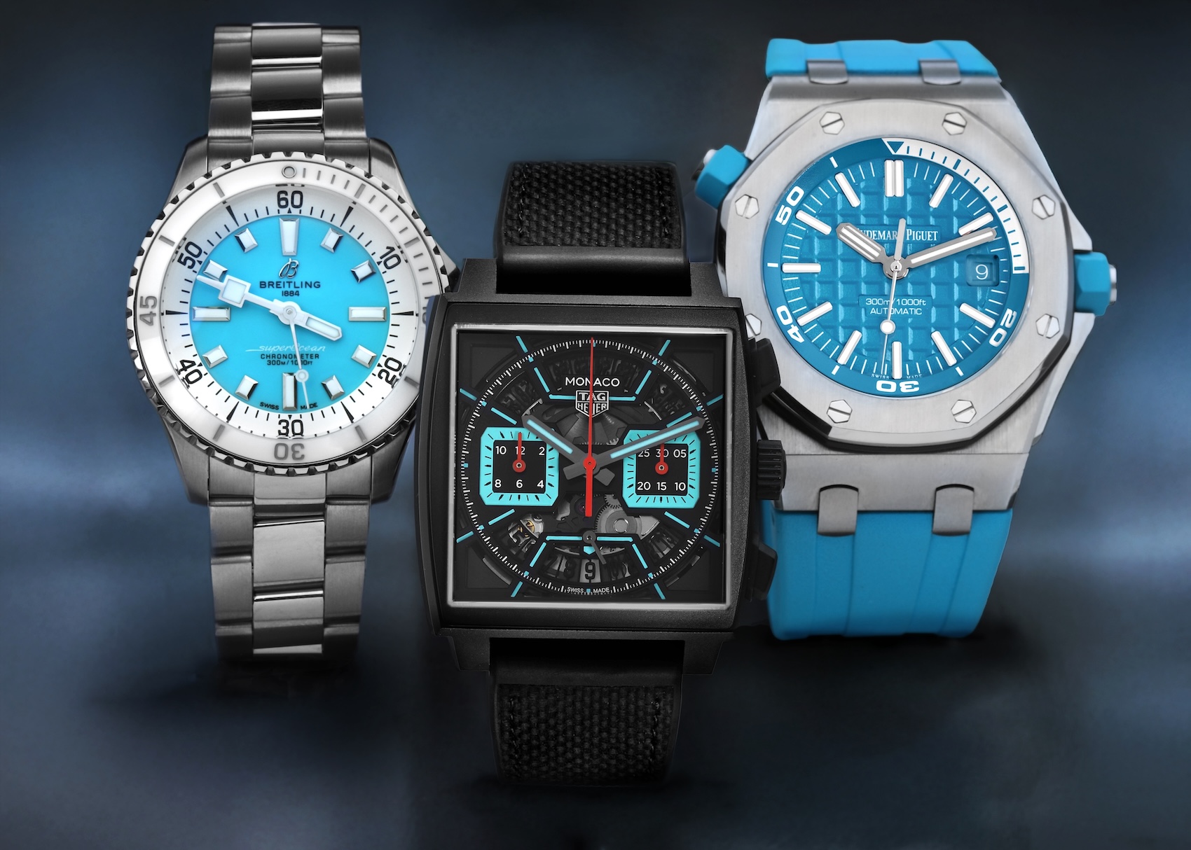 Trio of luxury watches featuring turquoise dials and accents, including a Breitling Superocean, Tag Heuer Monaco, and Audemars Piguet Royal Oak Offshore.