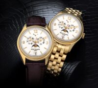 Two Patek Philippe Annual Calendar 5146J watches side-by-side, comparing the brown leather strap with the solid yellow gold multi-link bracelet.