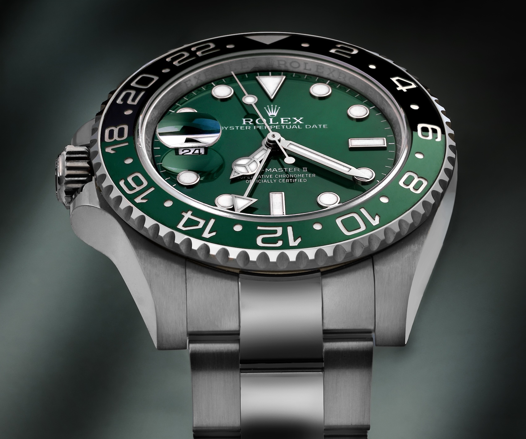 Close-up of the left-handed Rolex GMT-Master II with a green and black Cerachrom bezel on an Oyster bracelet.